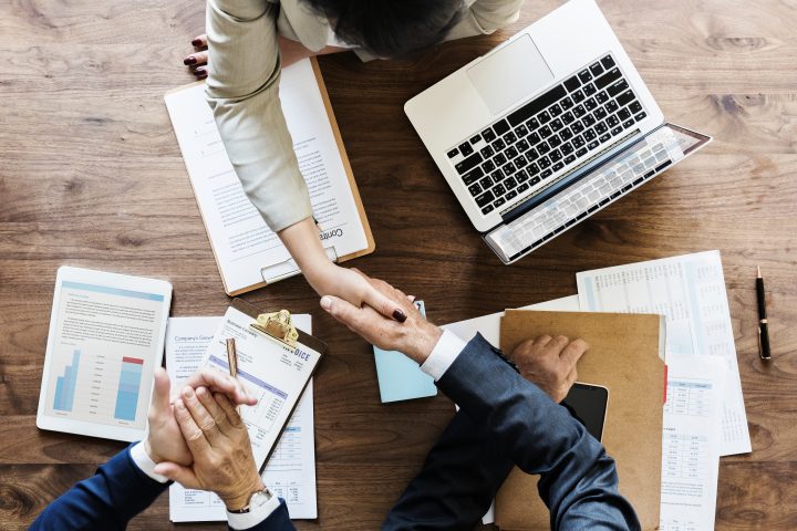 business people shaking hands together
