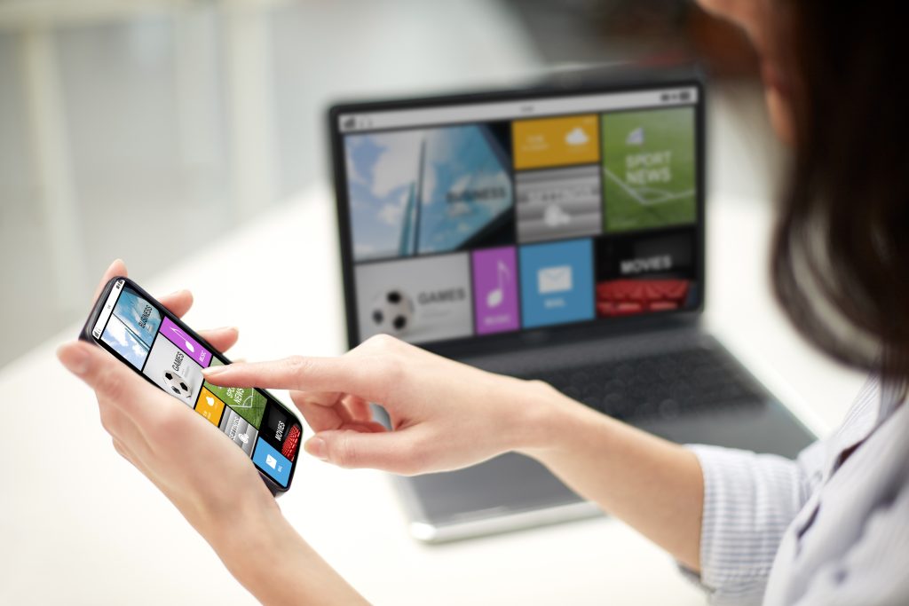 business technology people concept close up woman hands with laptop computer smartphone office