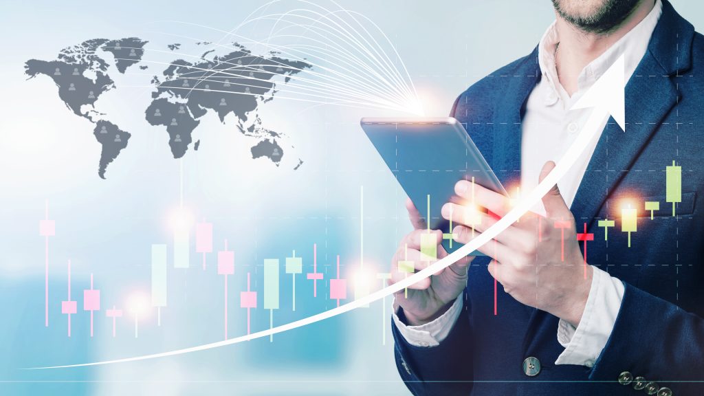 double exposure businessman using tablet with cityscape financial graph blurred buildi