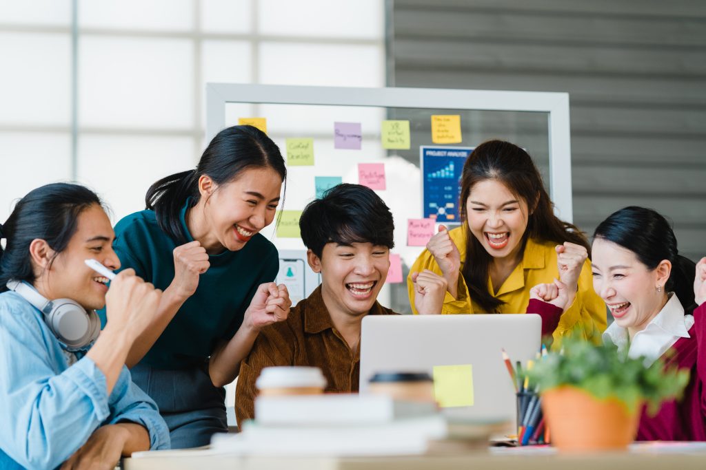 group asia young creative people smart casual wear discussing business celebrate giving five after dealing feeling happy signing contract agreement office coworker teamwork concept
