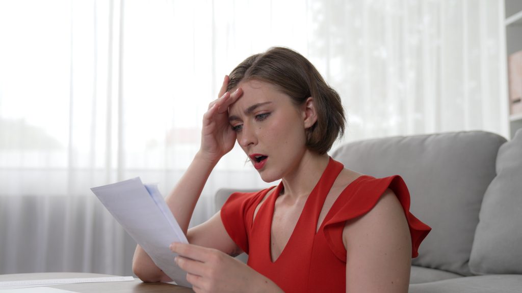 stressed young woman has financial problems credit card debt pay prim