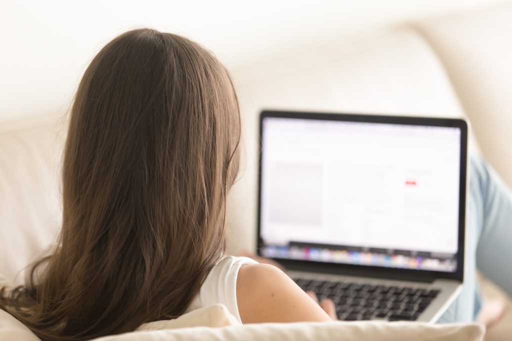 woman using laptop comfortable sofa home