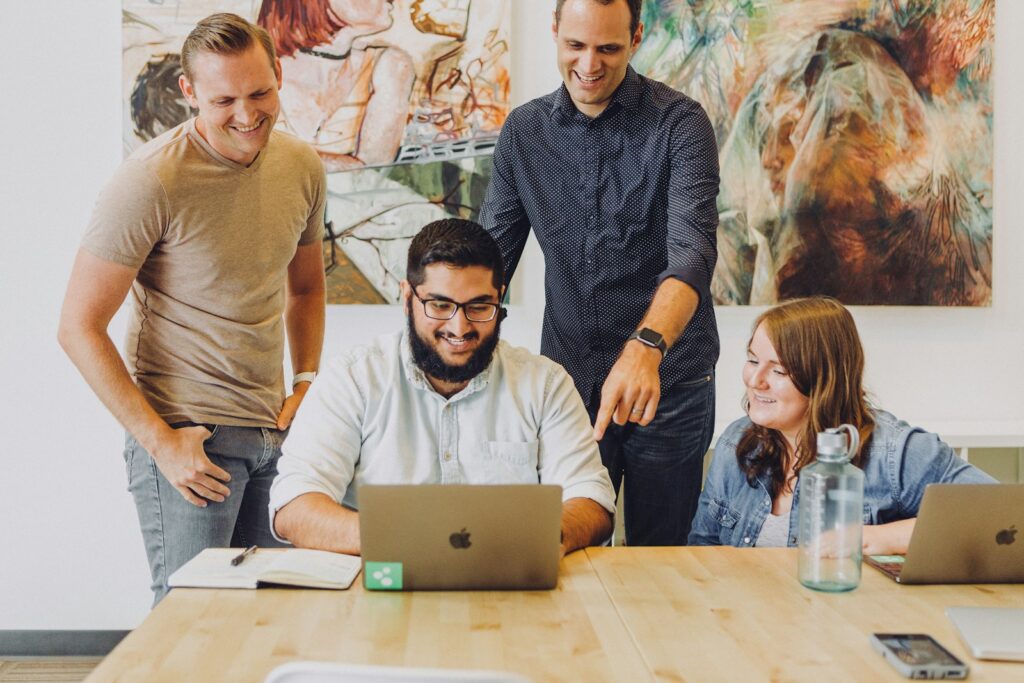 Business team reviewing advertising results together on a laptop