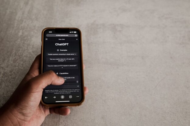 Hand holding a smartphone with ChatGPT open