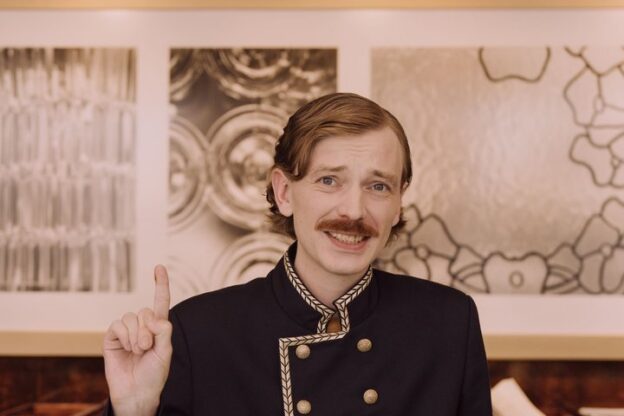 Hotel concierge welcoming guests at the front desk