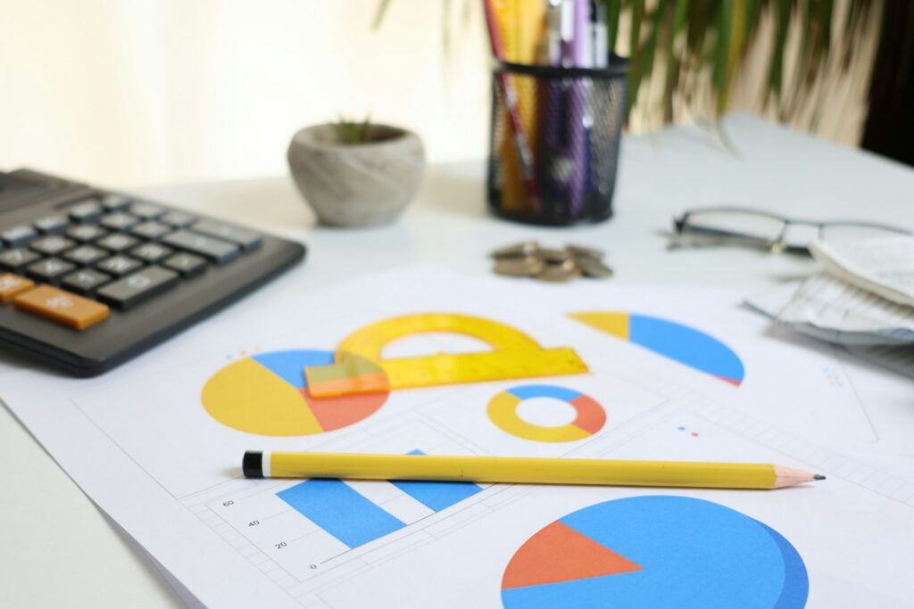 Desk with calculator and charts for planning a ChatGPT Ads budget