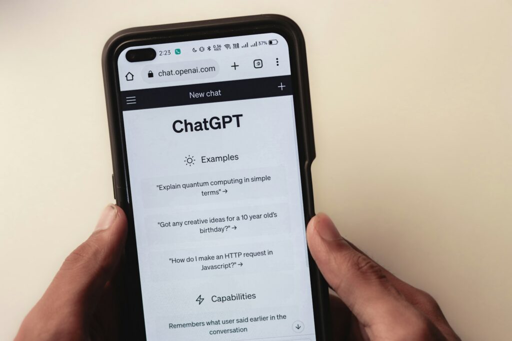 Person holding a phone with a ChatGPT conversation on screen