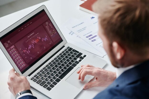 Marketer reviewing an analytics dashboard on a laptop