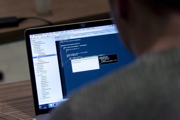 Developer working on code on a laptop
